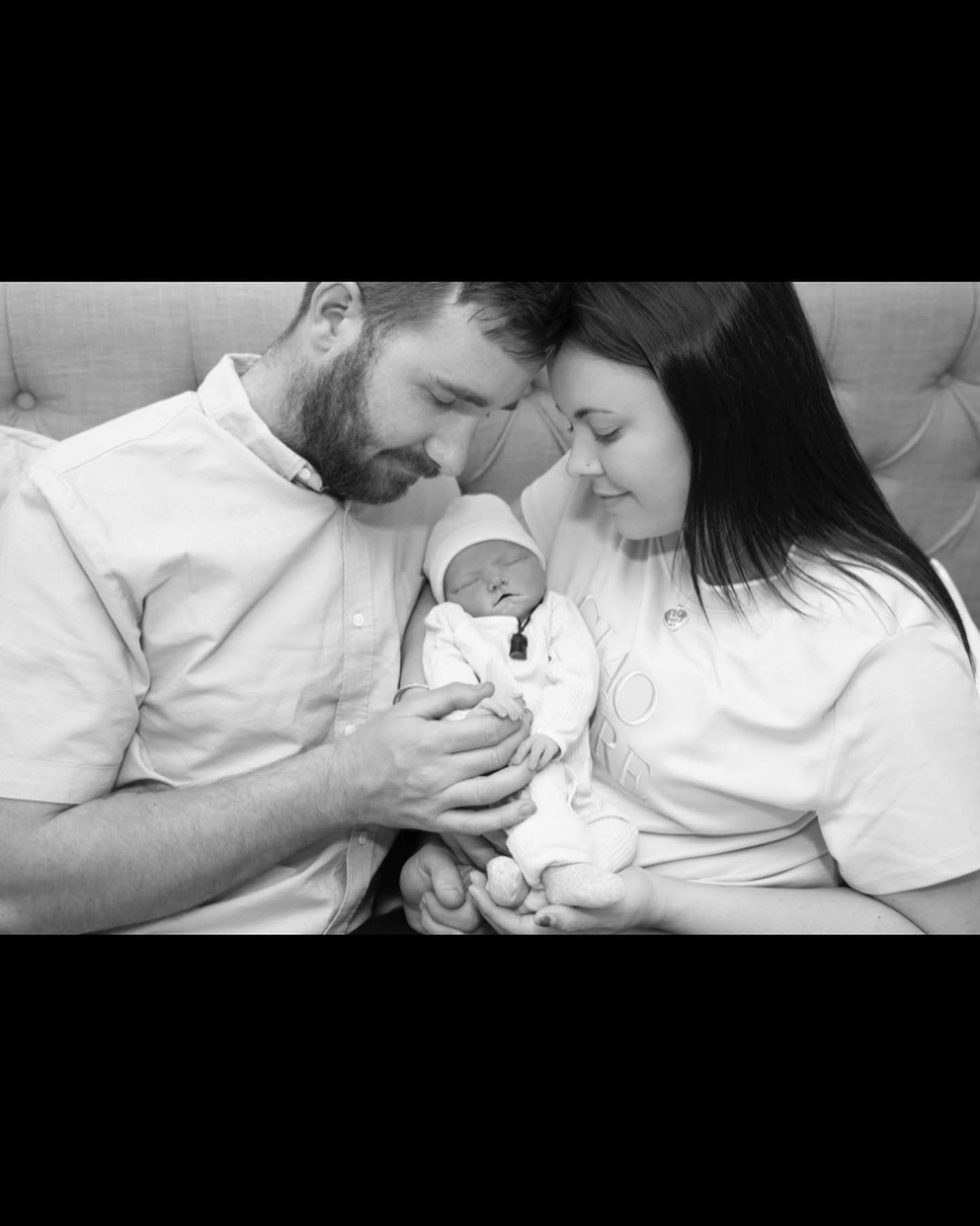 Baylee and Rach holding their son Jasper together
