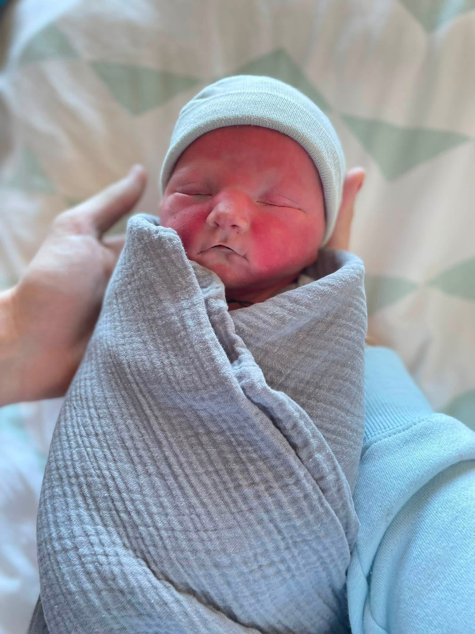 Jasper as a newborn, lovingly held